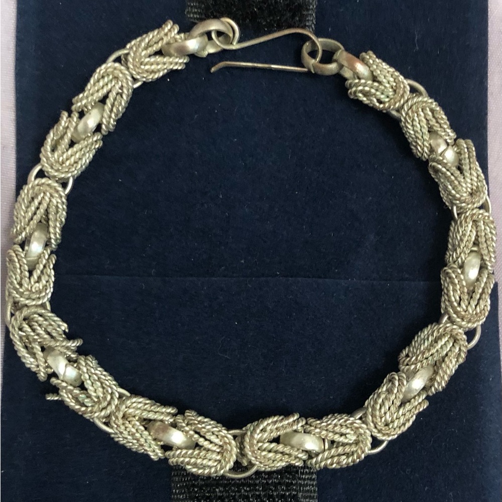 Dainty silver-plated bracelet from Egypt with hook-style closure.